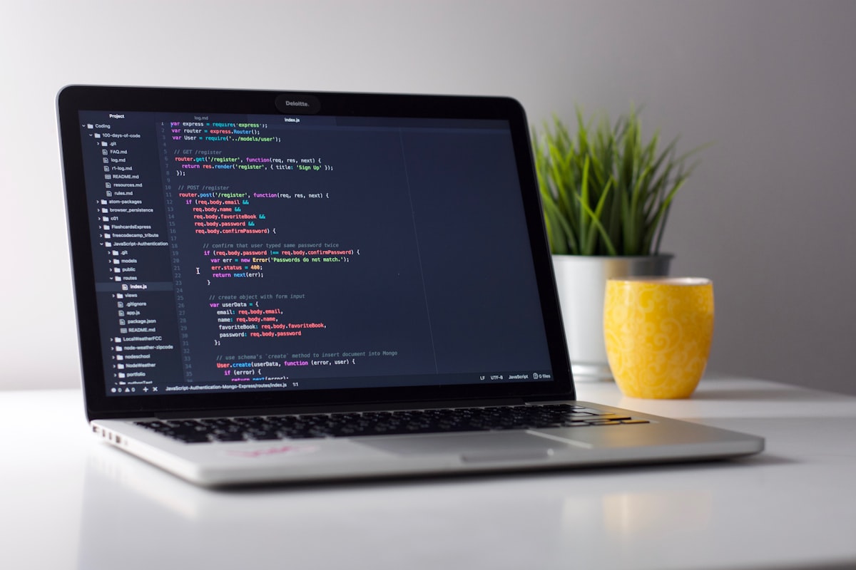 Laptop showing code editor with syntax highlighting