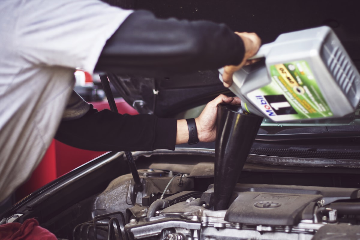 Mechanic working on car engine in auto shop