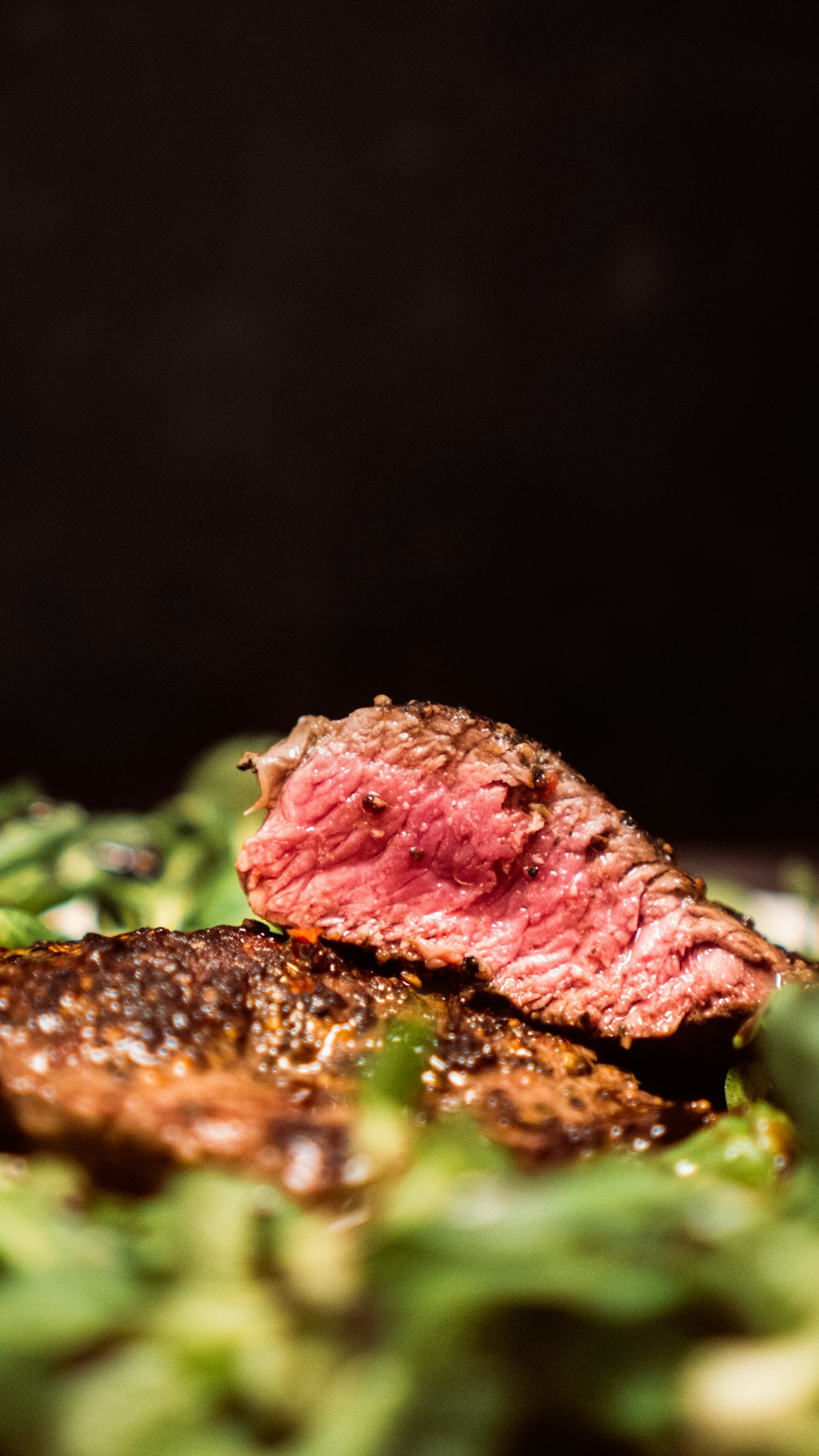 Perfectly seared steak resting on a cutting board with herbs