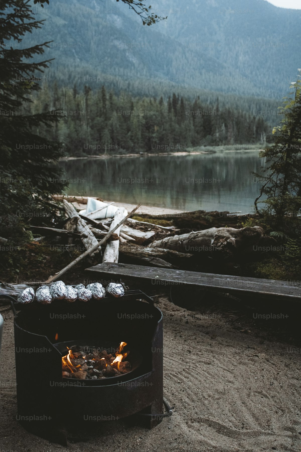Warm campfire burning in a stone fire ring at dusk